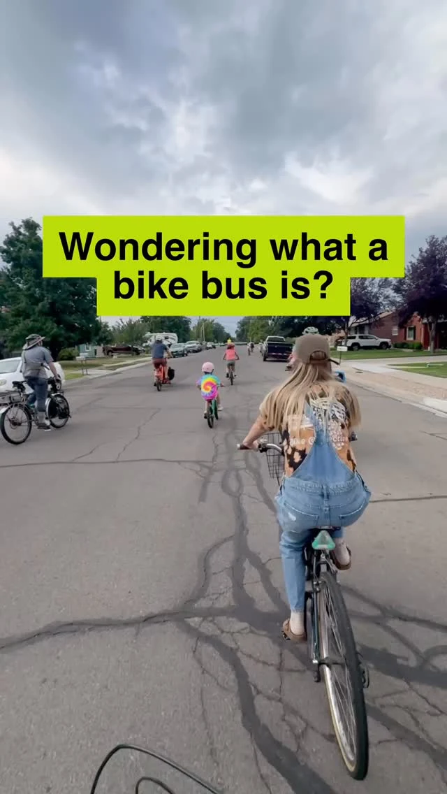 Adults and kids riding bikes together on a neighborhood street.
