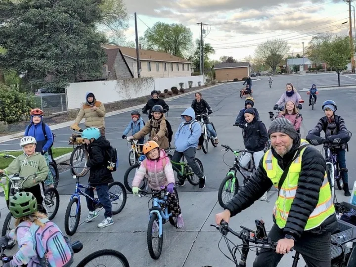 Kids and adults gathered with bicycles for a school bike bus.